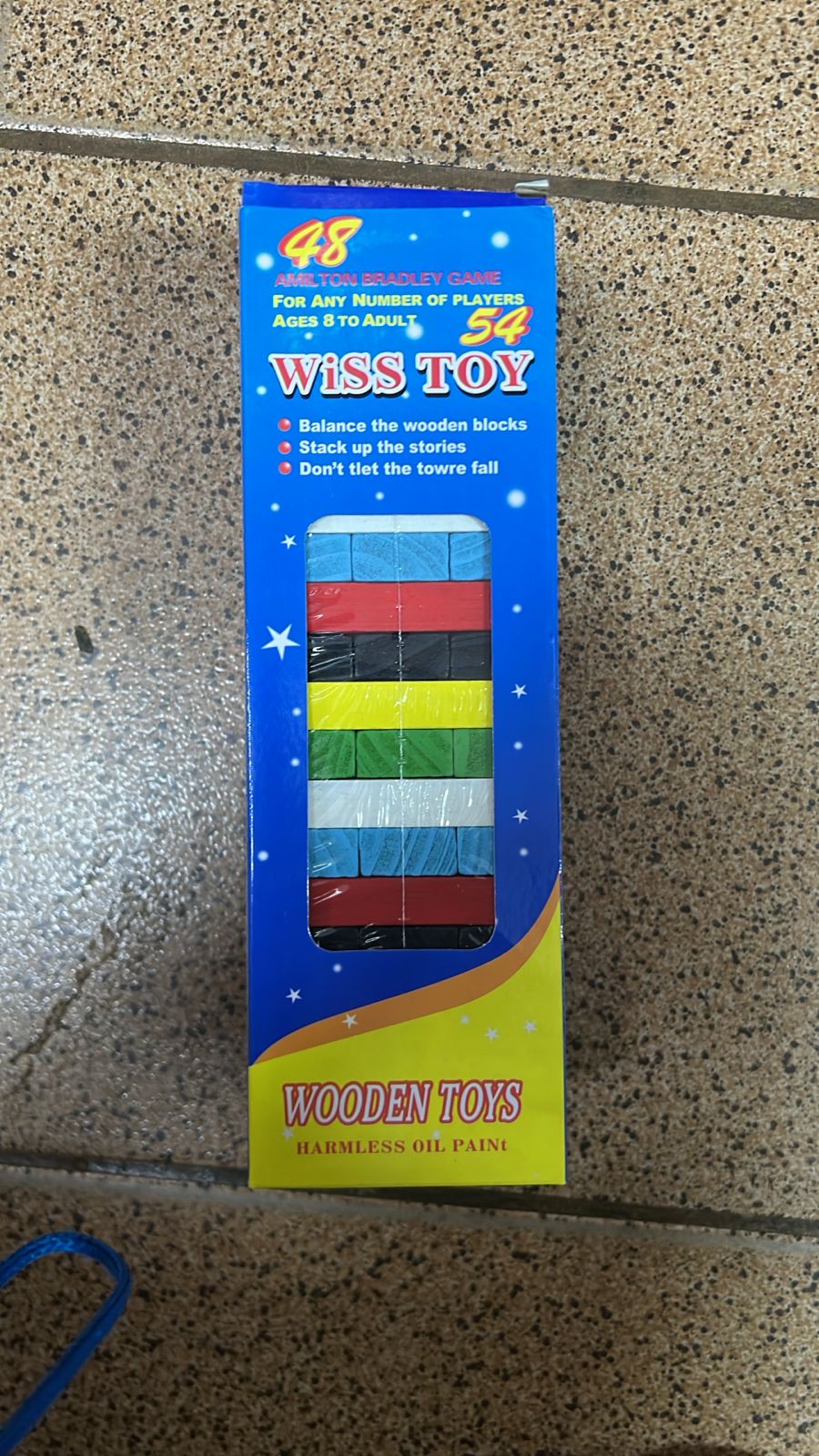 Juego de torre tembleque de madera colorida con dado